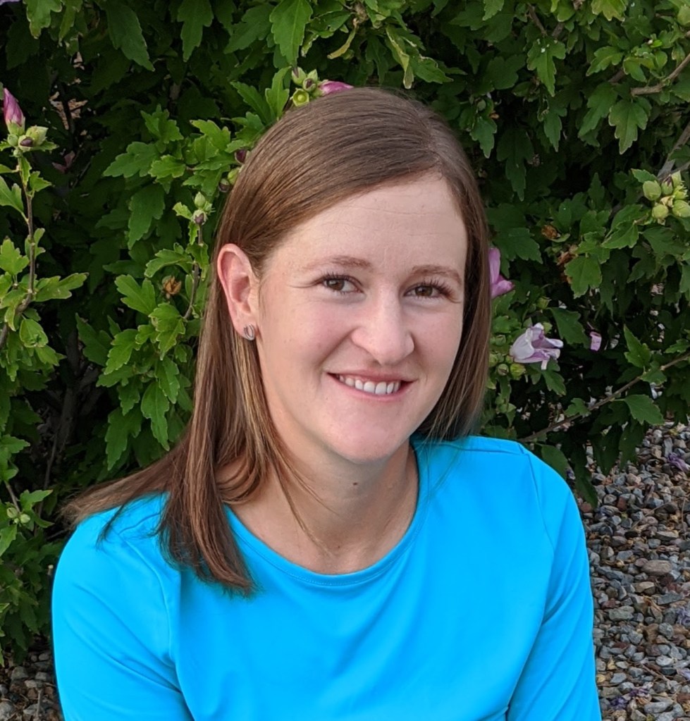 white woman with brown hair and a turquoise shirt